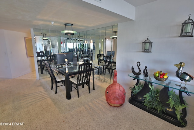 dining area featuring light colored carpet