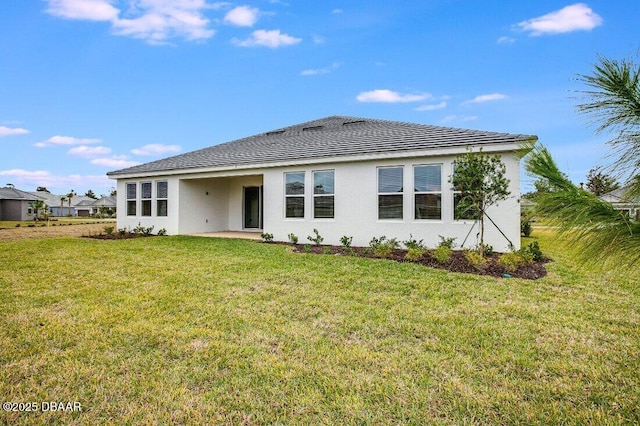 rear view of property with a lawn