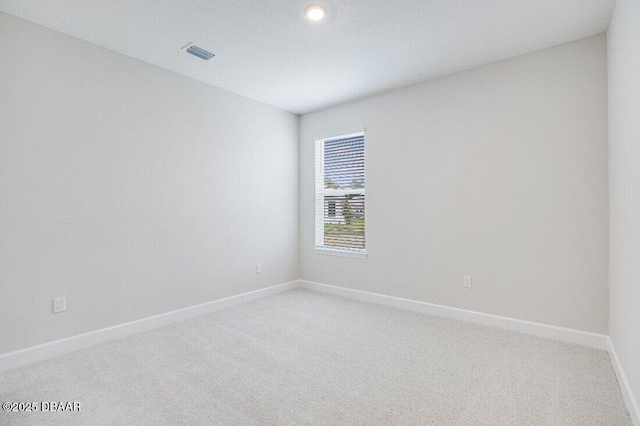 empty room featuring carpet floors and a textured ceiling