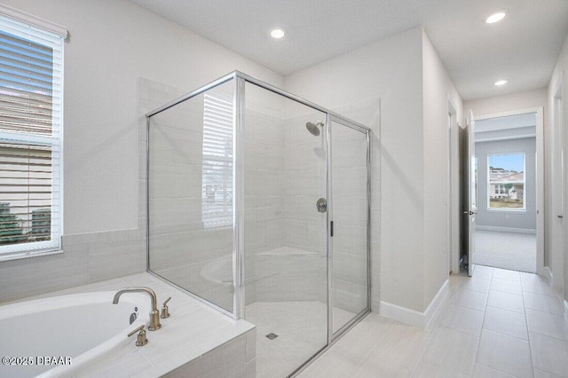 bathroom featuring separate shower and tub