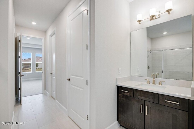 bathroom featuring vanity, tile patterned flooring, and a shower with shower door