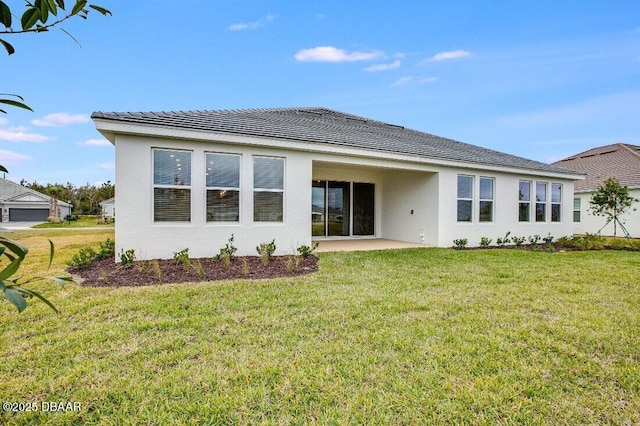 rear view of house featuring a yard and a patio area