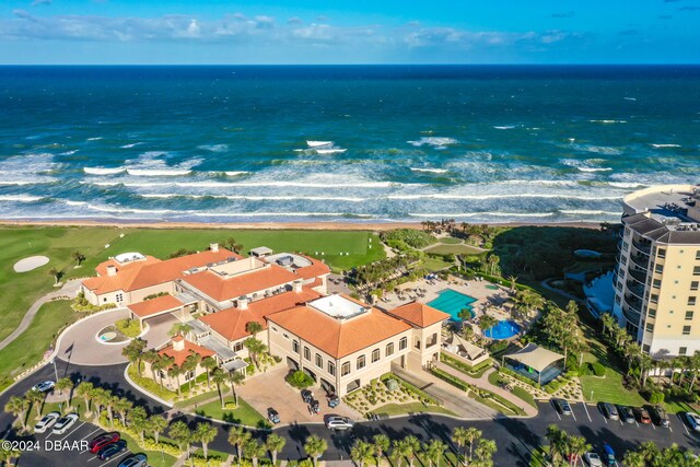 bird's eye view featuring a water view and a beach view