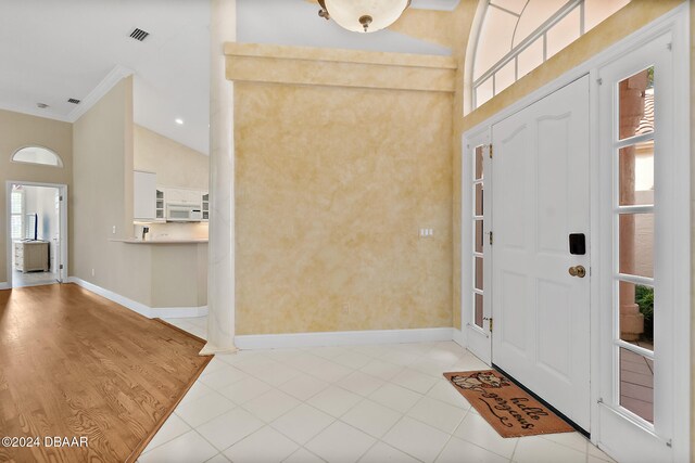 entrance foyer with lofted ceiling and light wood-type flooring