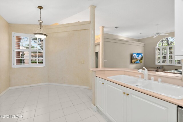 kitchen featuring pendant lighting, plenty of natural light, white cabinetry, and lofted ceiling