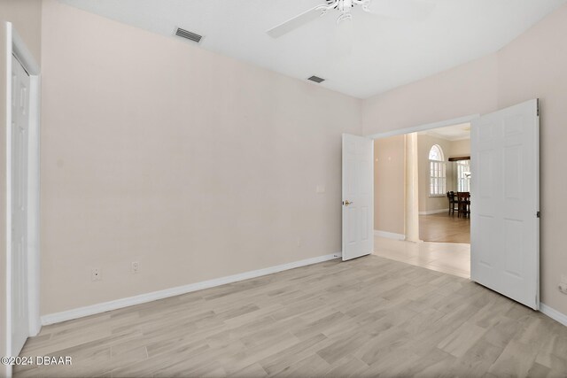 spare room featuring light wood-type flooring and ceiling fan