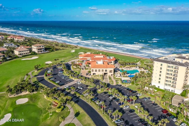 birds eye view of property featuring a water view and a beach view