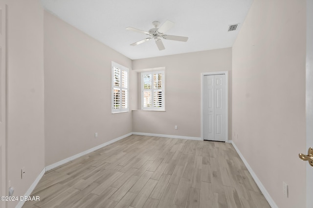 empty room featuring ceiling fan and light wood-type flooring