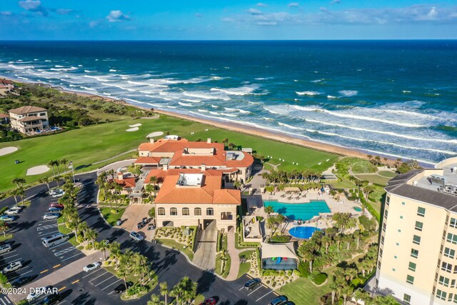 drone / aerial view with a water view and a view of the beach