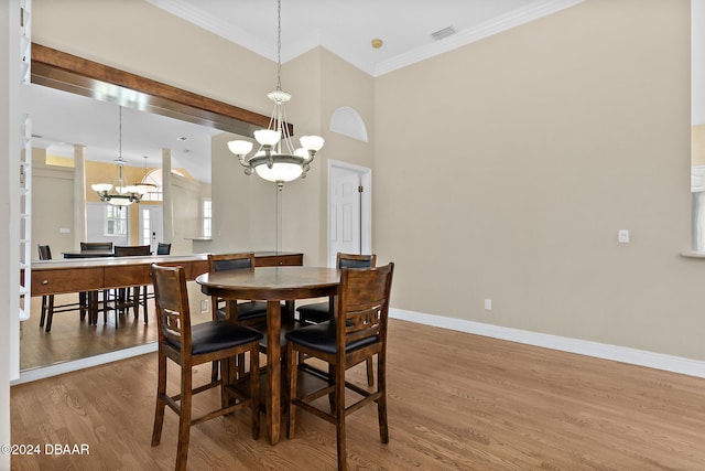 dining room featuring hardwood / wood-style floors, a notable chandelier, and crown molding