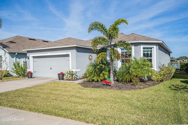 view of front of property featuring a garage and a front yard