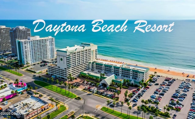 drone / aerial view with a water view and a view of the beach