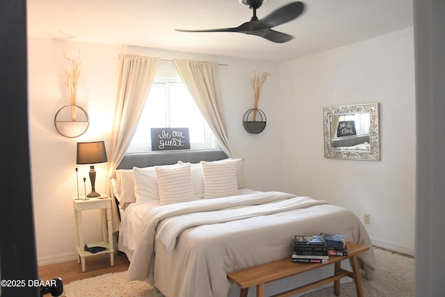 bedroom featuring baseboards and ceiling fan