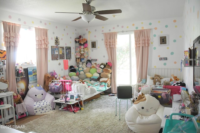 bedroom featuring wallpapered walls and a ceiling fan