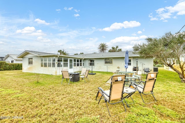 back of house featuring a yard