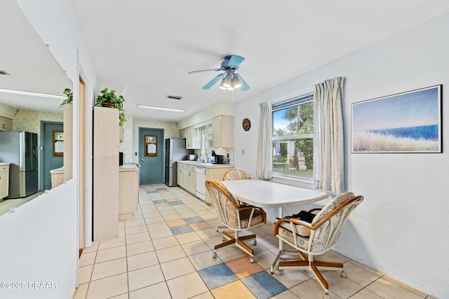 tiled dining area with ceiling fan