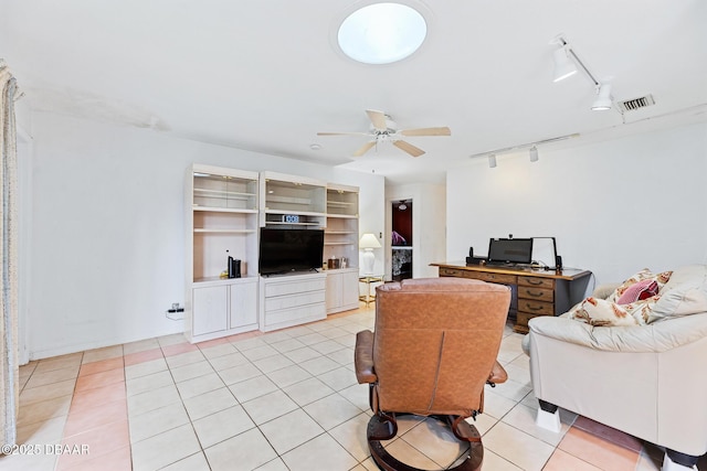 tiled living room featuring ceiling fan and track lighting