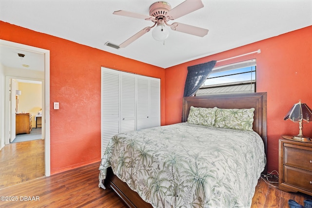 bedroom with ceiling fan, hardwood / wood-style floors, and a closet