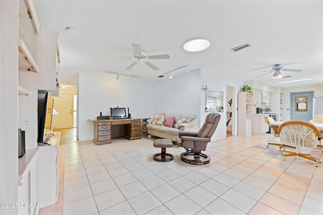 living room with ceiling fan, light tile patterned floors, and track lighting