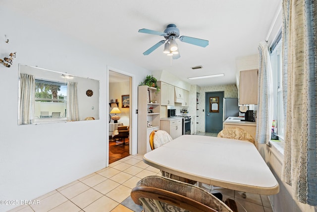 dining area featuring ceiling fan and light tile patterned flooring