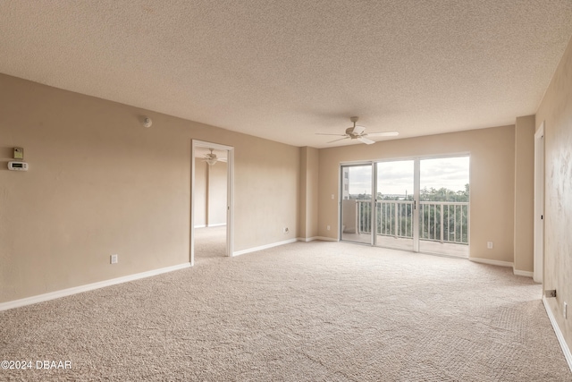 empty room featuring carpet, a textured ceiling, and ceiling fan