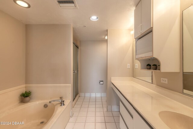 bathroom featuring tile patterned floors, plus walk in shower, and vanity