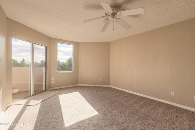 carpeted empty room with ceiling fan and a textured ceiling