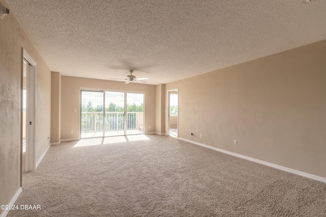 carpeted empty room featuring a textured ceiling and ceiling fan