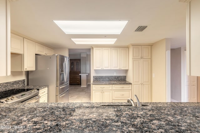 kitchen with sink, cream cabinetry, and appliances with stainless steel finishes