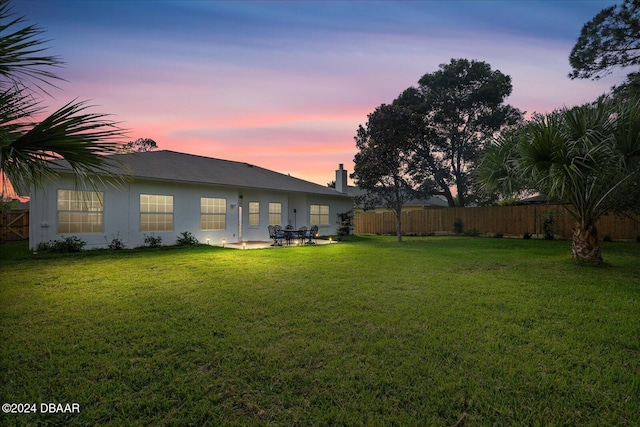 yard at dusk with a patio