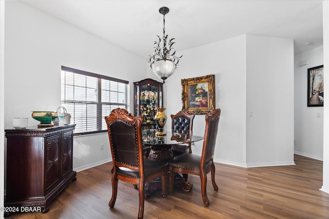 dining area featuring a chandelier and dark hardwood / wood-style floors