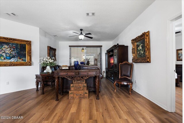 interior space with ceiling fan, hardwood / wood-style floors, and a textured ceiling