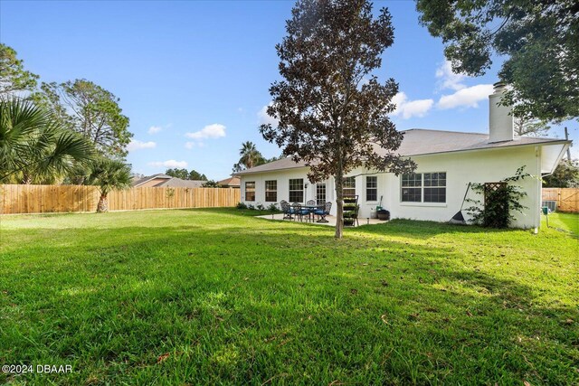 back of house with a yard