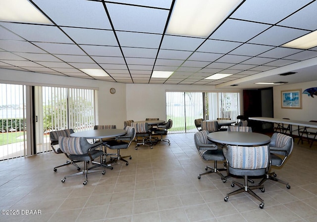 944 S Peninsula Dr Unit 104, Daytona Beach, FL 32118 - dining room with tile patterned floors and a paneled ceiling