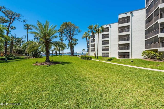944 S Peninsula Dr Unit 104, Daytona Beach, FL 32118 - view of home's community featuring a yard and a water view