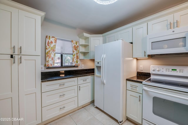 944 S Peninsula Dr Unit 104, Daytona Beach, FL 32118 - kitchen featuring white appliances, light tile patterned flooring, open shelves, dark stone counters, and white cabinets