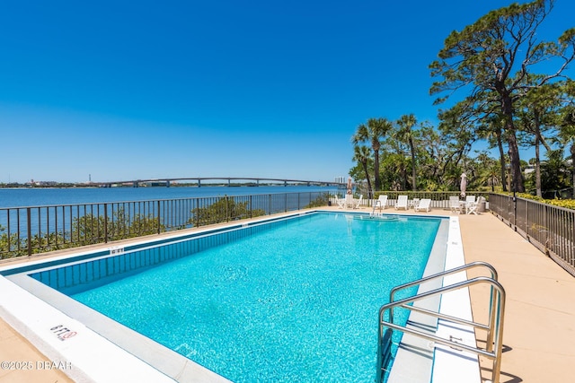 944 S Peninsula Dr Unit 104, Daytona Beach, FL 32118 - community pool with fence, a water view, and a patio area