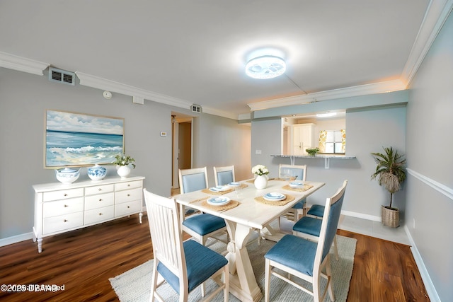944 S Peninsula Dr Unit 104, Daytona Beach, FL 32118 - dining space with ornamental molding, dark wood-type flooring, and baseboards