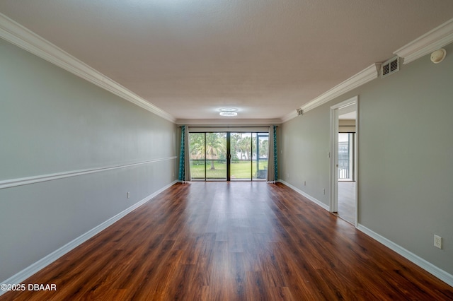 944 S Peninsula Dr Unit 104, Daytona Beach, FL 32118 - spare room featuring baseboards, dark wood-type flooring, and crown molding