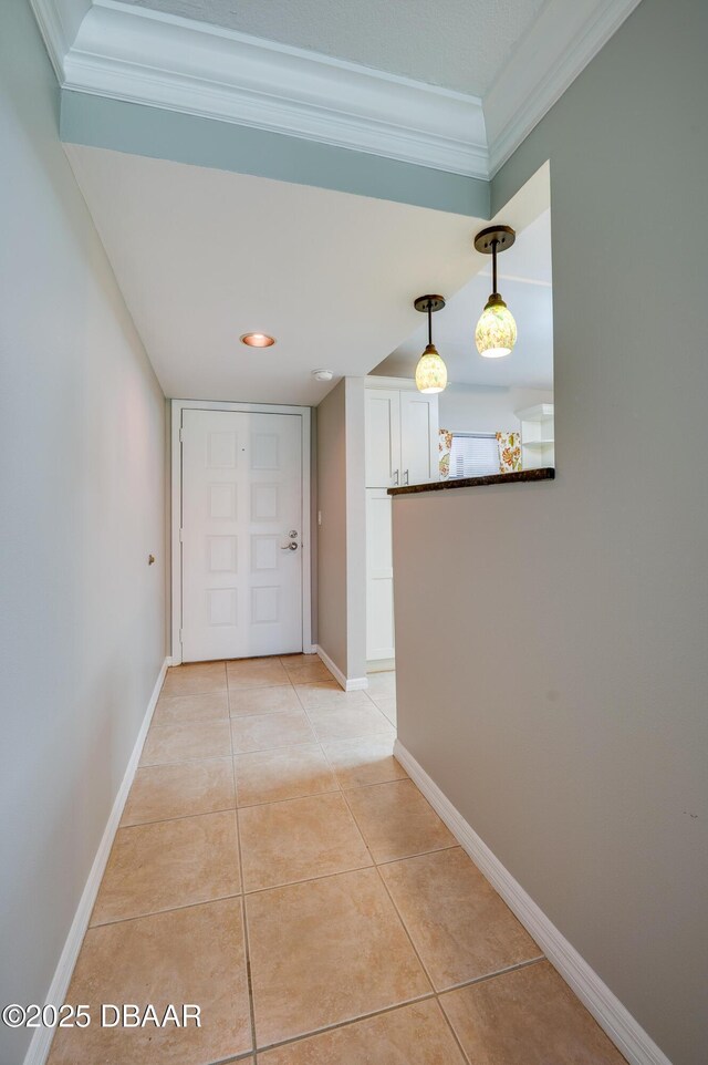 944 S Peninsula Dr Unit 104, Daytona Beach, FL 32118 - corridor featuring ornamental molding, light tile patterned floors, and baseboards