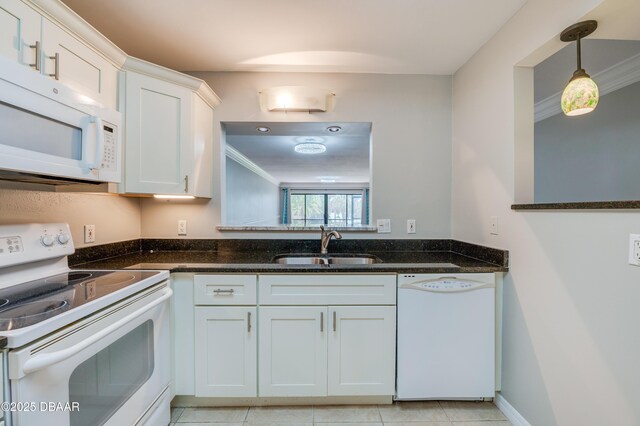 944 S Peninsula Dr Unit 104, Daytona Beach, FL 32118 - kitchen with white appliances, a sink, dark stone counters, white cabinetry, and decorative light fixtures