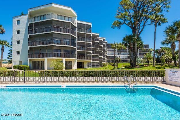 944 S Peninsula Dr Unit 104, Daytona Beach, FL 32118 - community pool featuring fence