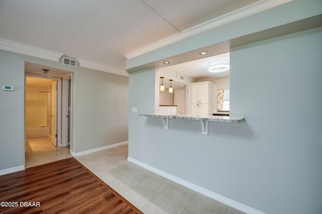 944 S Peninsula Dr Unit 104, Daytona Beach, FL 32118 - empty room with light tile patterned floors, ornamental molding, and baseboards