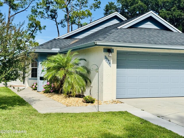 528 Crooked Stick Dr, Daytona Beach, FL 32114 - view of front facade with a shingled roof, stucco siding, driveway, a garage, and a front lawn