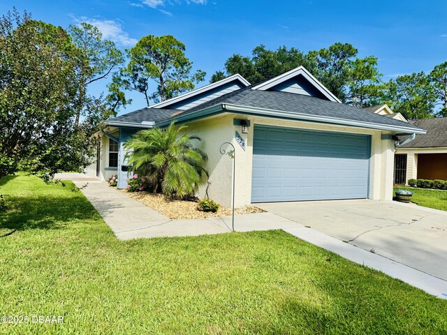 528 Crooked Stick Dr, Daytona Beach, FL 32114 - view of front of home with concrete driveway, stucco siding, an attached garage, and a front lawn