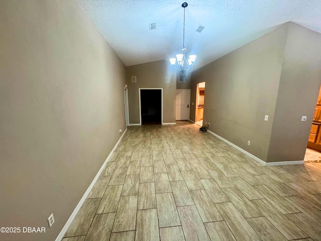 528 Crooked Stick Dr, Daytona Beach, FL 32114 - unfurnished living room featuring wood tiled floors, a chandelier, lofted ceiling, and a textured ceiling
