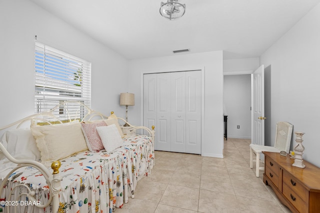 tiled bedroom with a closet