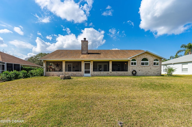 rear view of house featuring a lawn