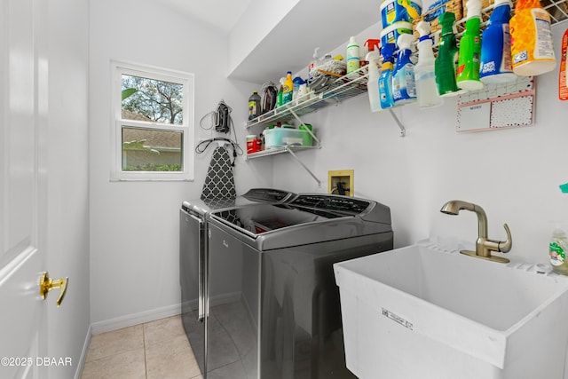 washroom with washer and clothes dryer, sink, and light tile patterned floors