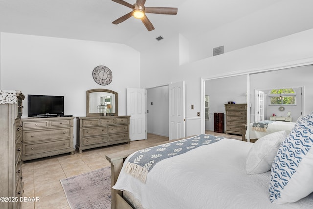 tiled bedroom with high vaulted ceiling and ceiling fan